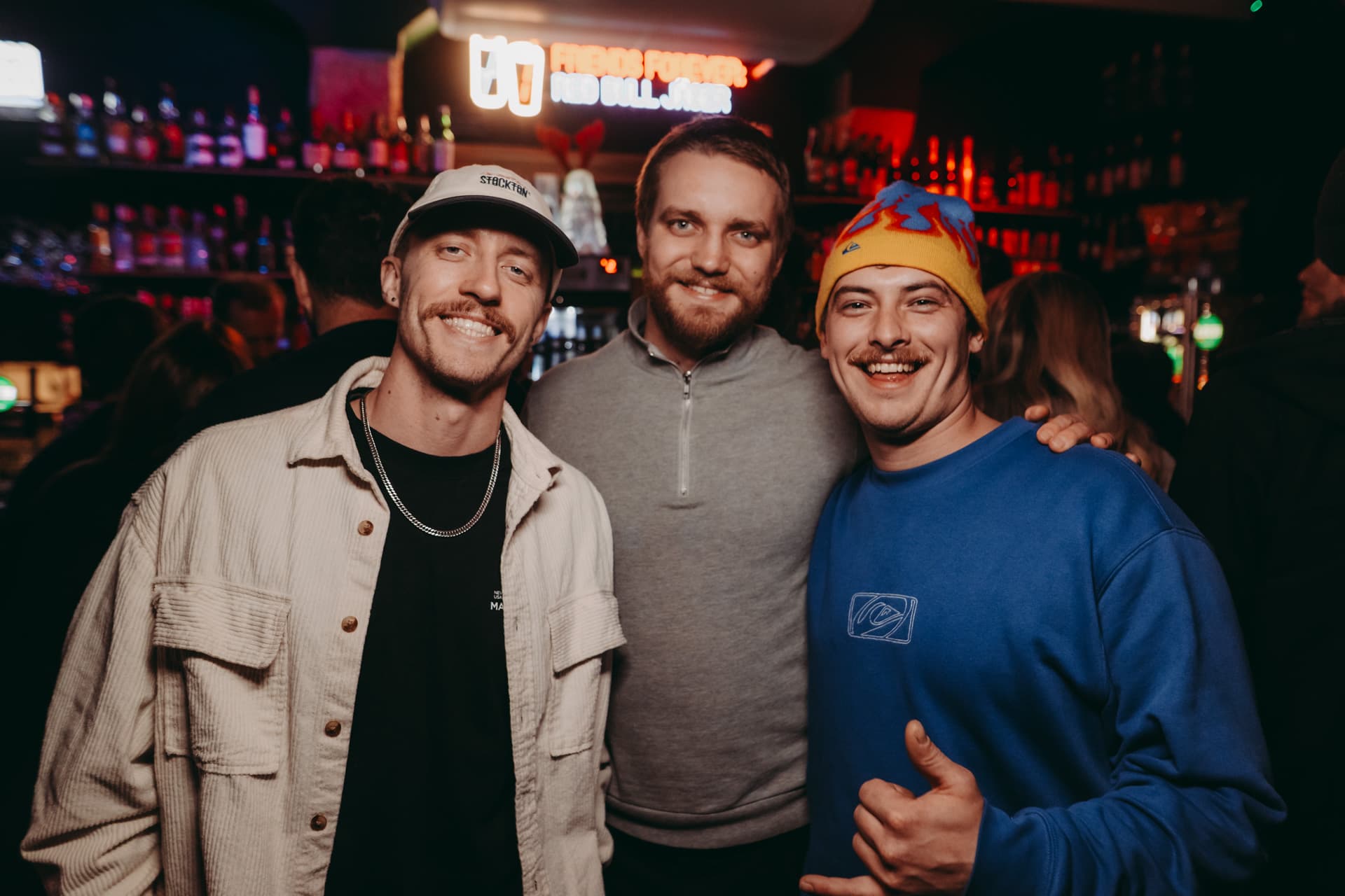 Three friends posing together at a Krakow club stop