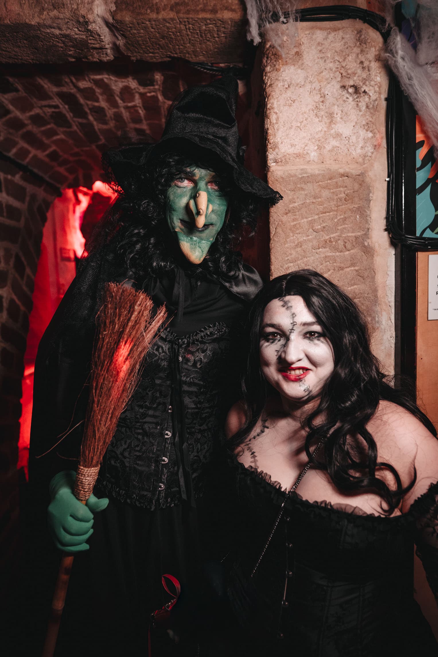 Halloween guests dressed as a witch and a stitched doll