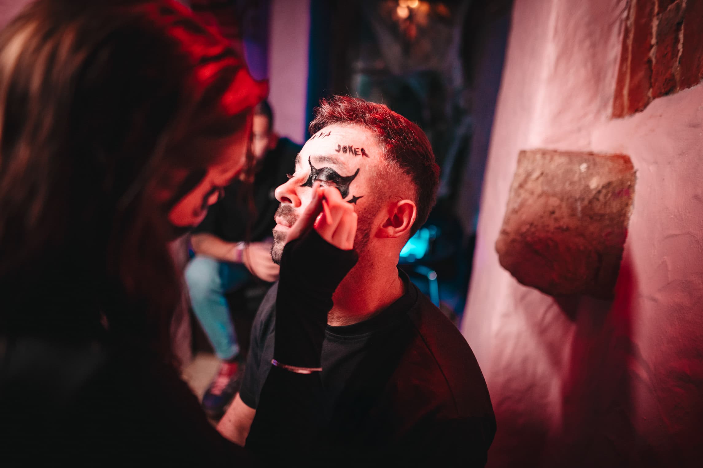 Guest having Halloween face paint applied at the opening venue