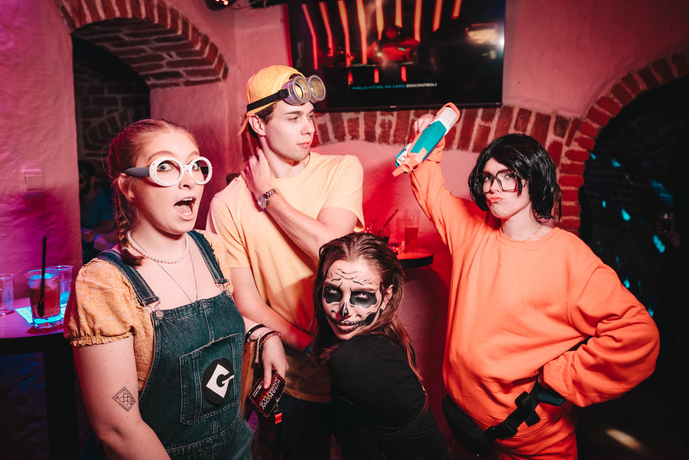 Friends in Minion costumes posing together during the pub crawl