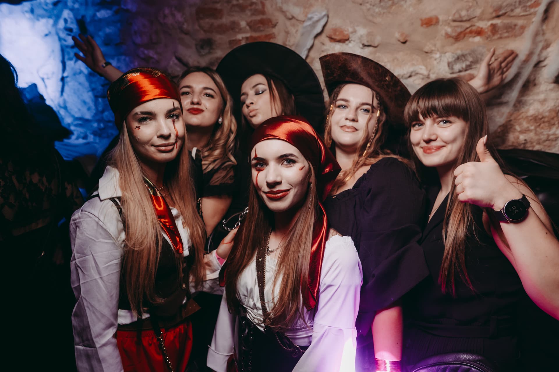 Friends in pirate costumes posing together on the Halloween crawl