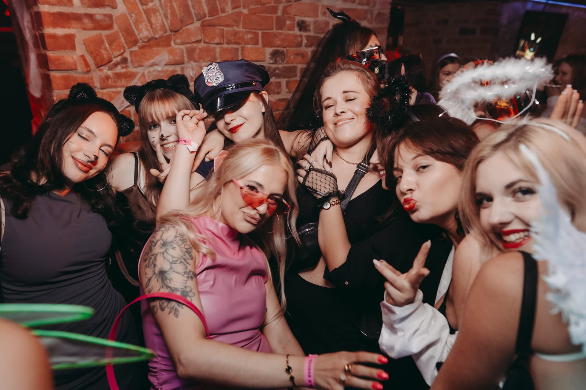 Costumed friends celebrating together inside the Halloween venue