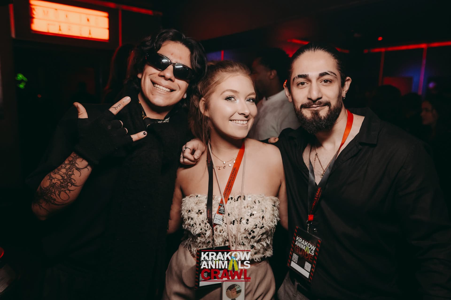 A guest celebrating with two Krakow Animals Crawl hosts